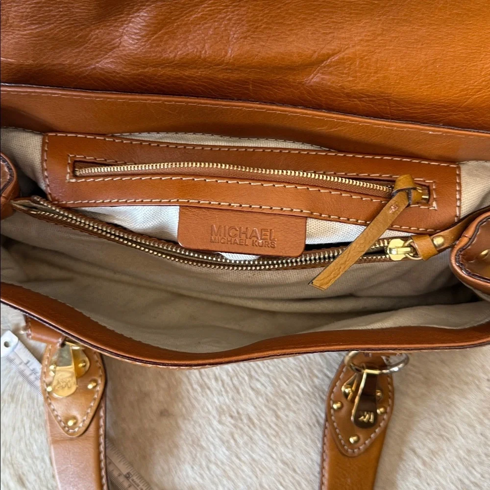 This is a vintage Michael Kors brown leather shoulder bag featuring gold studs